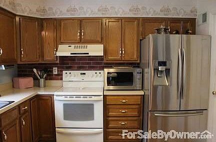 Kitchen
						:
						Samsung refrigerator, Kenmore glass-top range/oven, and Panasonic microwave.