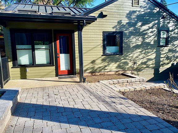 Facing back door: stone patio, with stone steps to lower level
