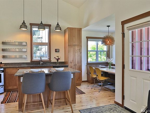 Enjoy granite countertops, stainless appliances and designer light fixtures in your spacious eat-in kitchen. 