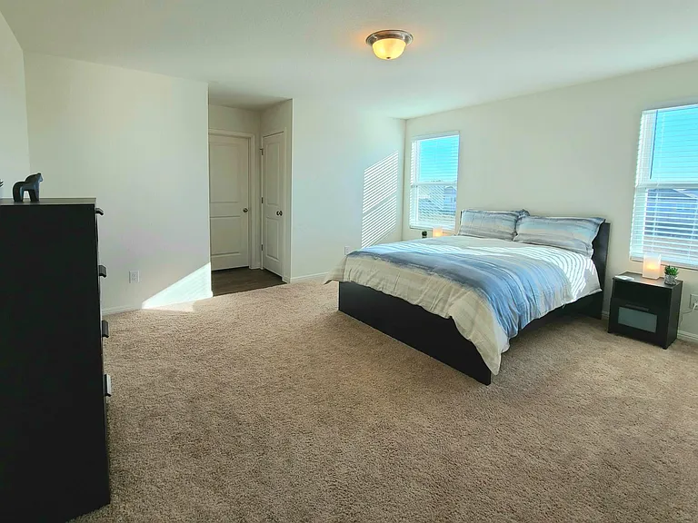 view of Bedroom #1, includes queen size bed, two night tables and lamps, 4-drawer dresser, full size mirror, private bathroom and huge walking closet.