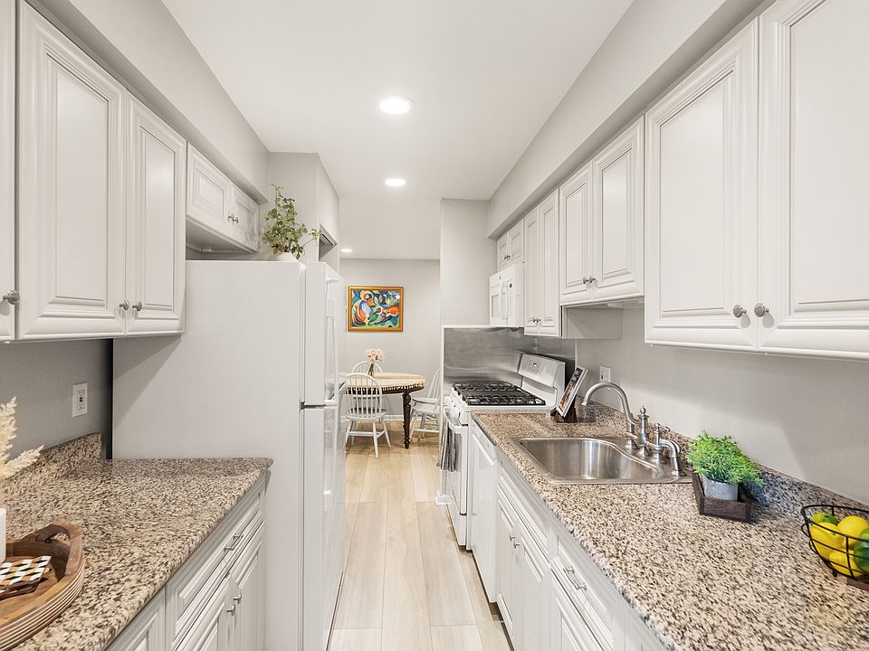 Galley kitchen with all major appliances (fridge, stove, dishwasher) replaced since 2020.