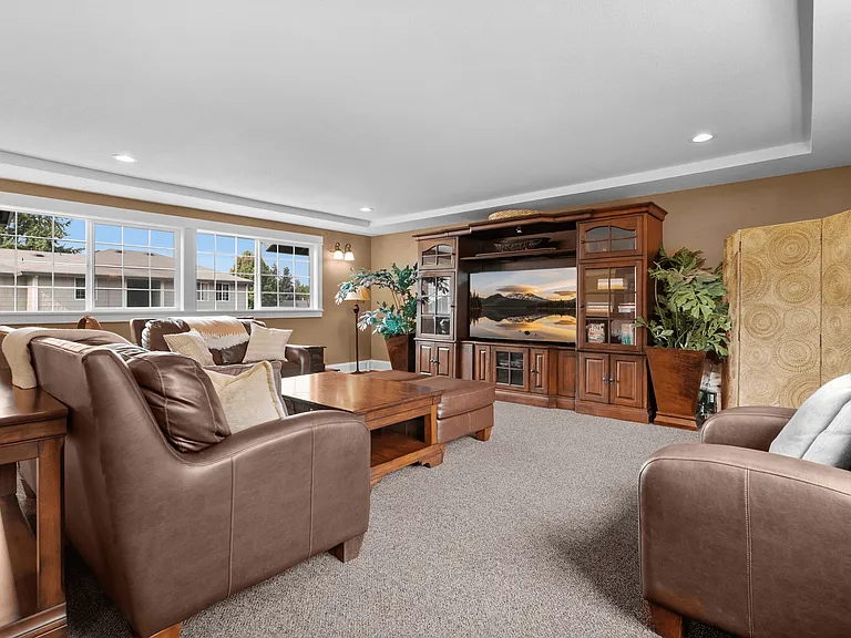 Comfortable resident lounge with cozy seating and TV entertainment.