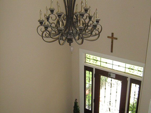 view of entry from upstairs showing off the high ceiling and tons of light