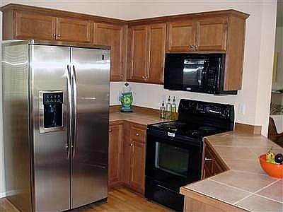 Kitchen w/ beautiful cabinets and tile countertops
