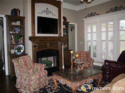 Living room has wood burning fireplace and beautiful built-ins