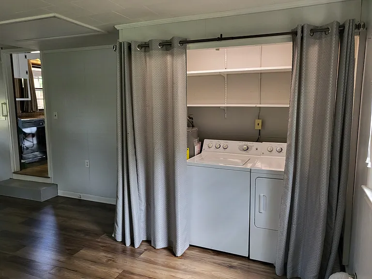 bonus room with laundry and hot water heater. more storage shelves