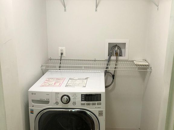 In unit combo washer dryer unit with oversized closet located in front bedroom.