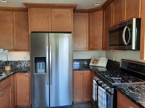 Kitchen with stainless steel appliances, beautiful cabinets with ample storage.