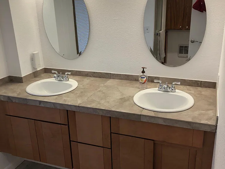 Newly renovated double vanity, new lights, toilet, shower, heater, fan, and new flooring