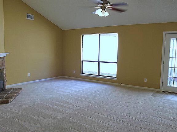 Wonderfully lit Family Room w/cozy fireplace & fresh paint!