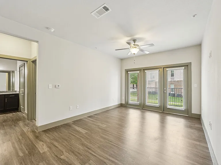 Enjoy the large windows in this spacious living room, leading out to the patio.