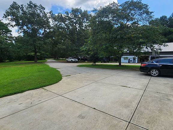 Enjoy a long cement driveway for easy access and ample parking. A separate garage on the property is rented out and not included, ensuring clear and private use of your space.