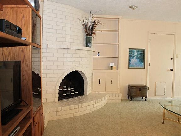 A closer look at the fireplace. Door leads to fully screened in Sun Room.
