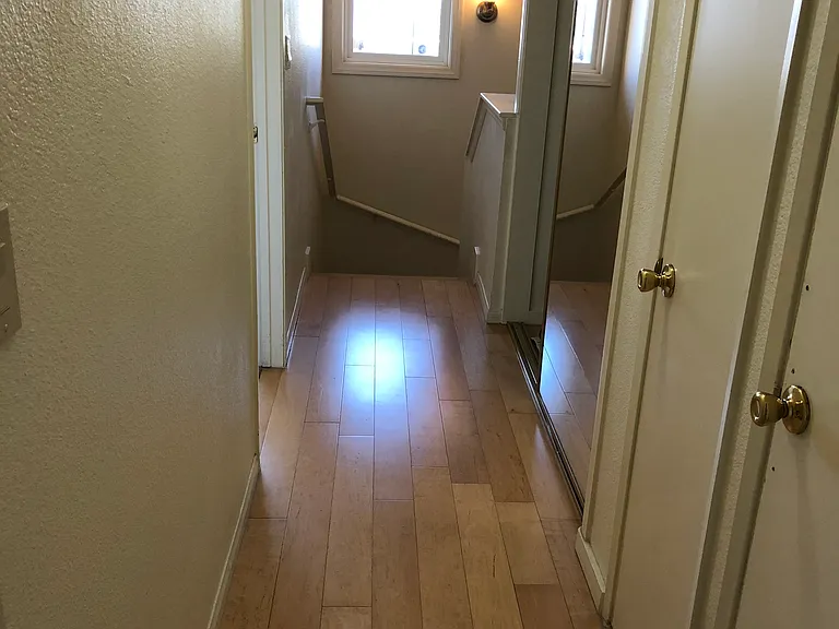 Upstairs hallway. Large storage closet on right side of picture with adjacent linen closet and central heater closet.