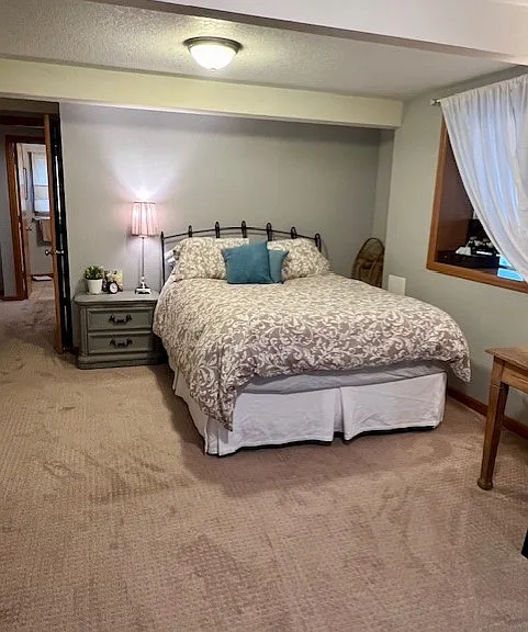 Bedroom view from rear of room. Queen bed and night stand.
