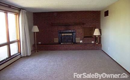 Living room with fireplace and woodbox