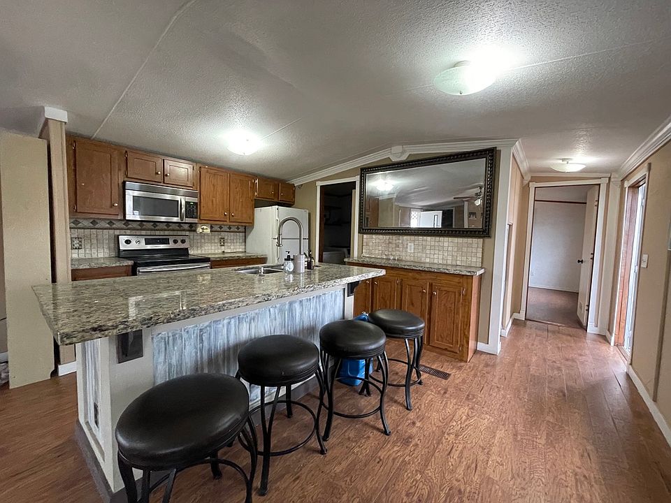 Granite counter-tops and open-concept kitchen to living-room