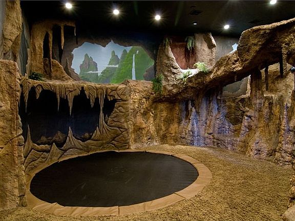 Cave with climbing wall, slide, Pirates of the Caribbean theme, trampoline