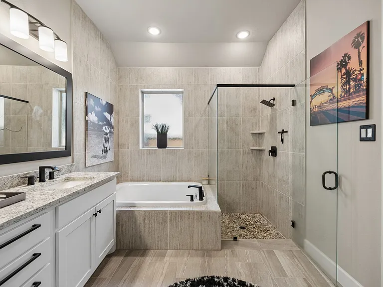 Upgraded walk-in shower with lots of tile and stone floor to ceiling