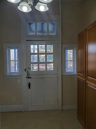 Private entrance into kitchen. Large pantry cupboards against wall.