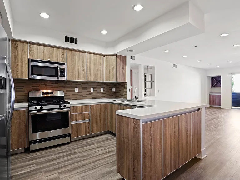 Open-Concept Kitchen with Energy-Efficient Appliances and Ample Cabinet Storage