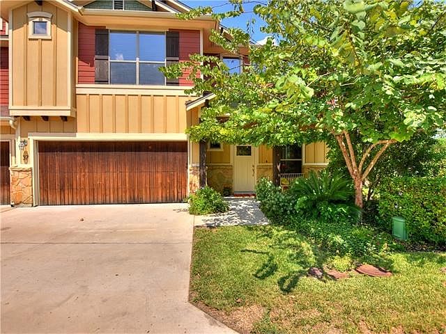 Front view of condo with attached 2 car garage
