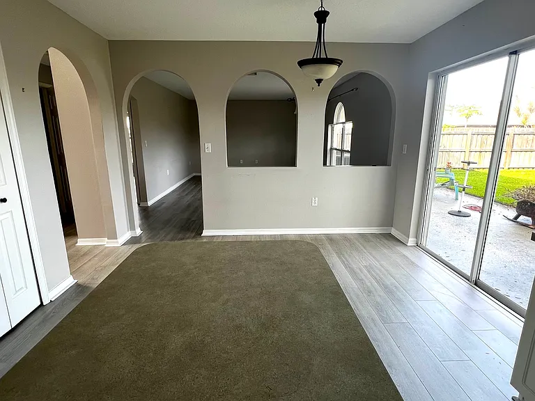 Kitchen Dinette Area with Sliding Door to Fenced-In Backyard