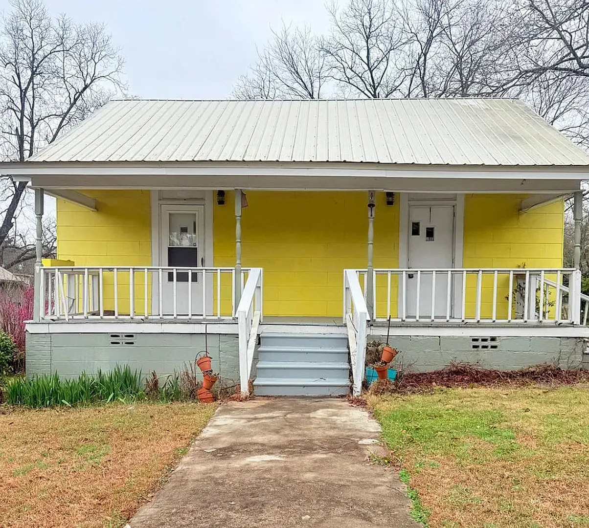 Charming 2-bedroom, 1-bath home in Opelika with a fenced yard, a large front porch, and a back deck. — Photo 1