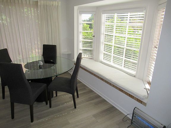 Bay Window with view of backyard with fruit trees.