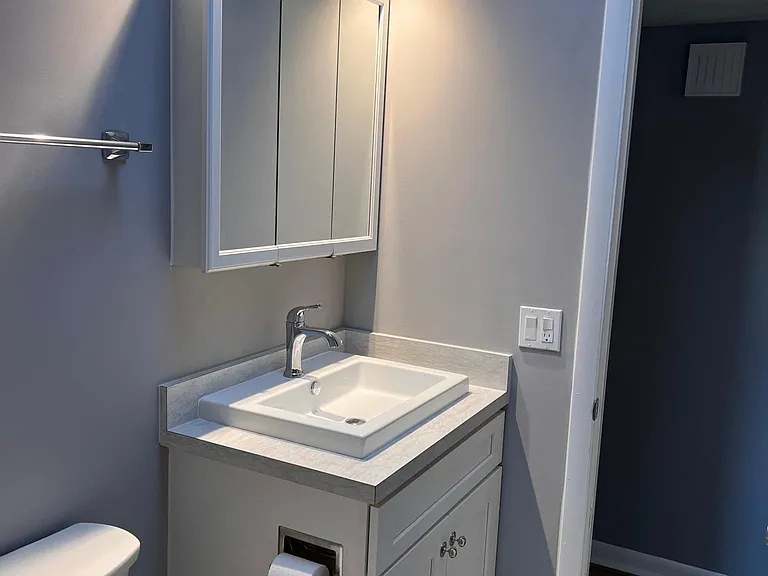 New common bathroom with new tile,fixtures,sink ,vanity and toilet.