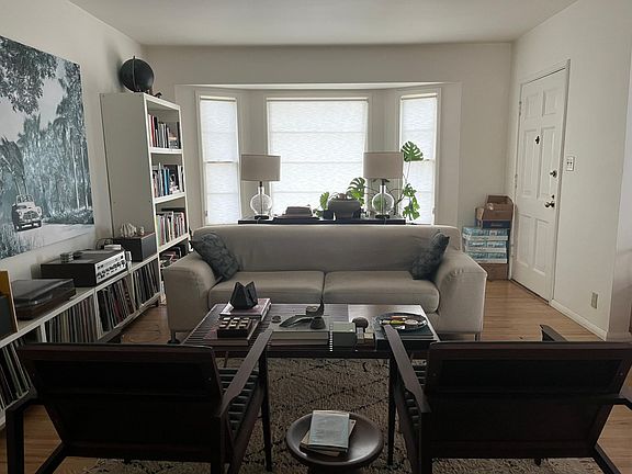 Bay window in living room front door on the left.