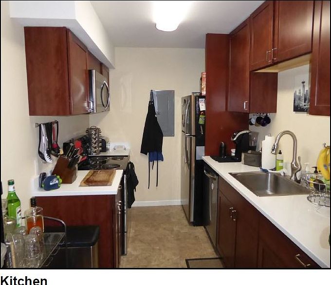 Kitchen with all new stainless steel appliances, cherry hardwood cabinets, and white granite countertops.