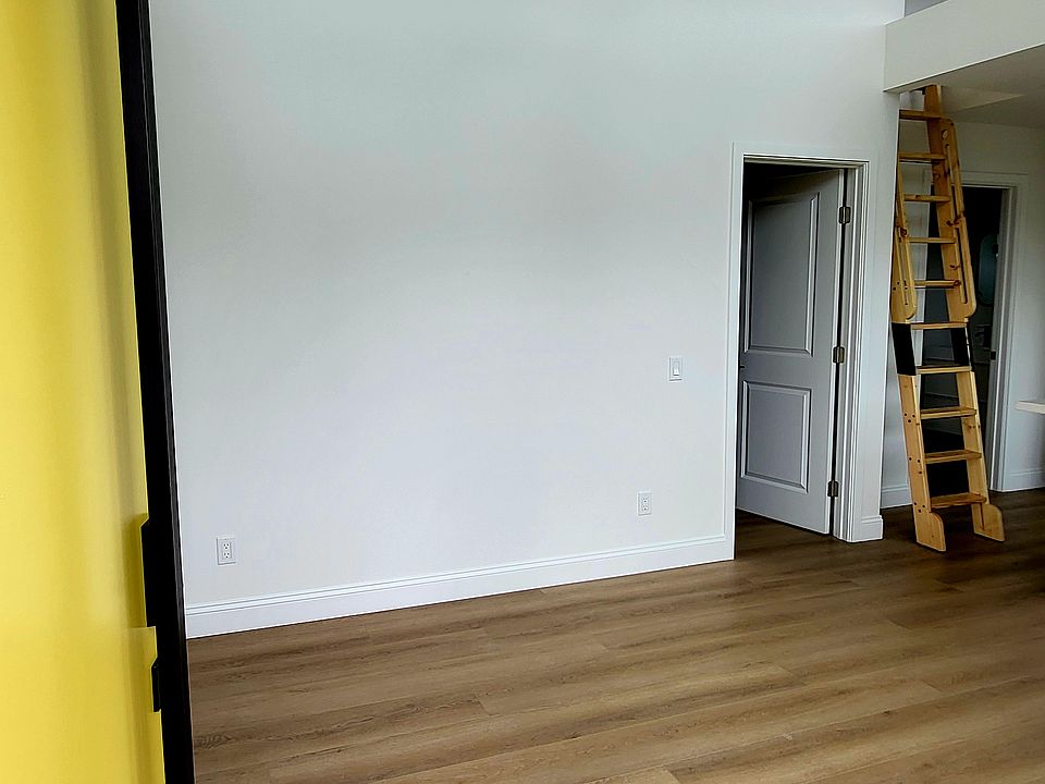 Living room. Door on right is the bedroom. Ladder to the right is to the loft that has a low ceiling.
