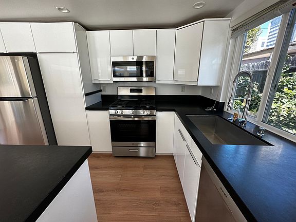 Large Kitchen with central island. Brand new stove/oven, microwave, and refrigerator.