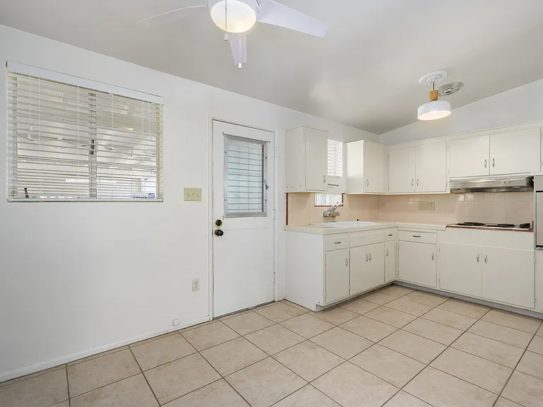 Kitchen, carport entry door and dining area