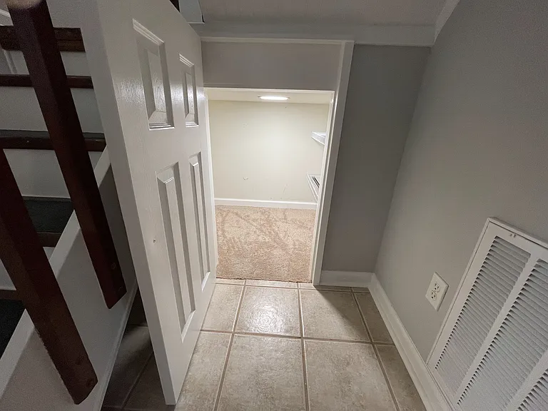 Under stairs landing storage with shelving and recessed lighting
