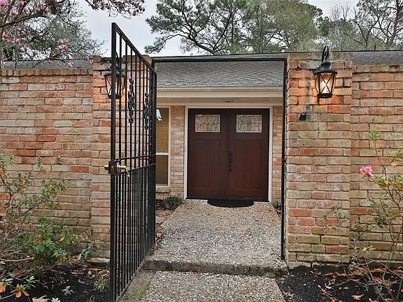 Brick wall and iron gate create and private courtyard entrance