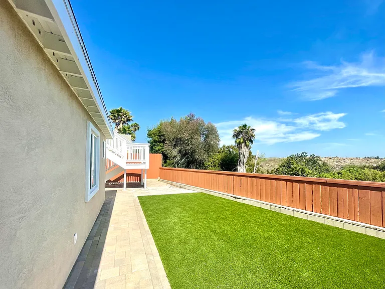 Backyard along the canyon with turfed lawn
