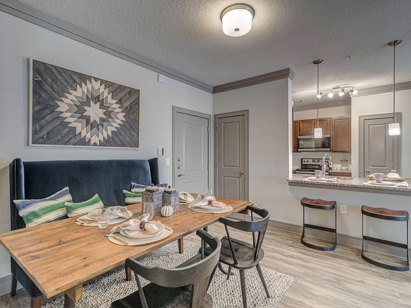 Kitchen with pendant lighting and dining area with hard-surface flooring