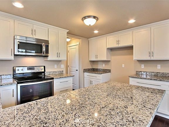 New Kitchen with flattop stove, dishwasher, garbage disposal, stainless steel fridge with water/ice dispenser (not pictured), quiet close cabinets, granite countertops, lazy Susan corner cabinet and walk up pantry.