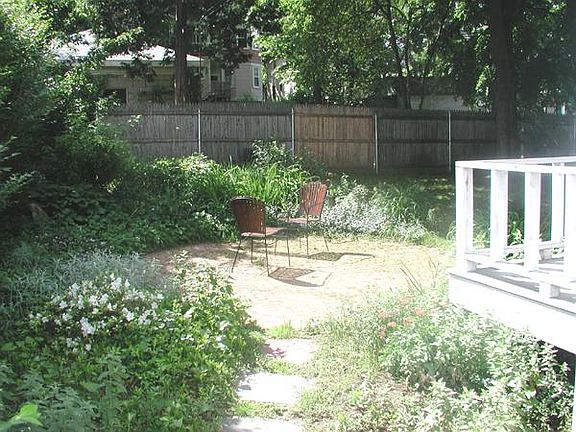 Shared back yard with brick patio.
