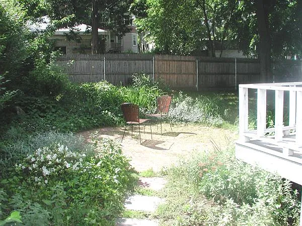Shared back yard with brick patio.