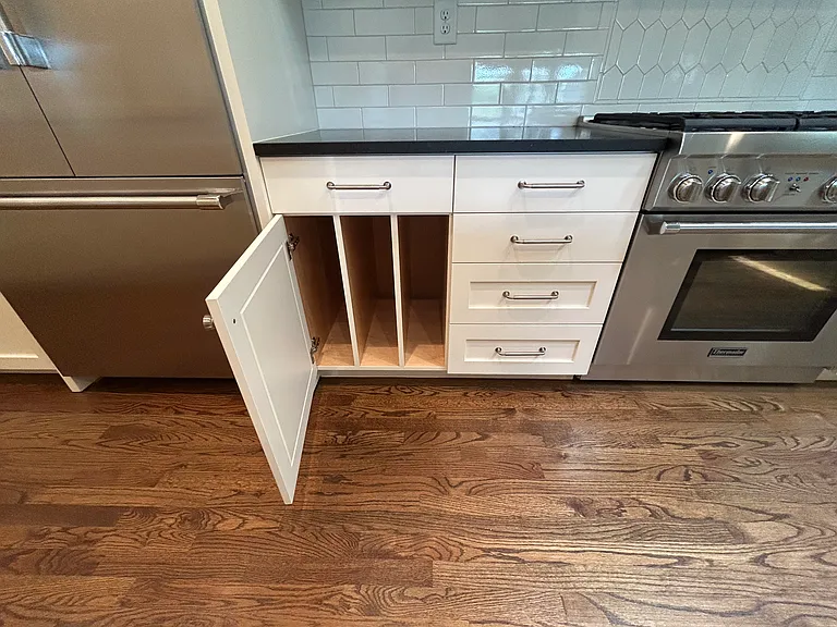 Such organized storage in this home w/cookie sheet/cutting board thoughtful additions.