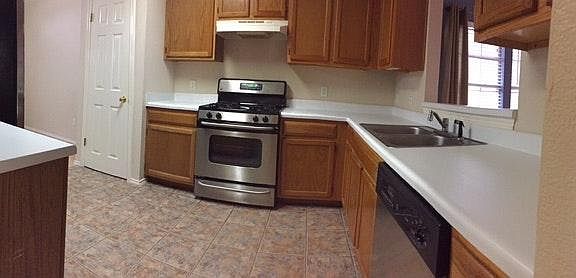 Kitchen includes stainless steel appliances, including stove
