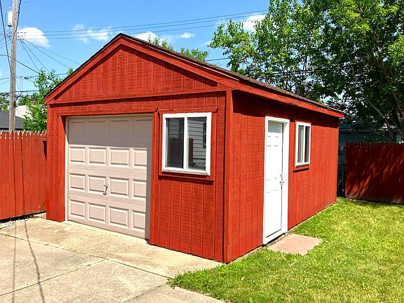 Fenced backyard. 15 car garage has electricity and remote-controlled door.