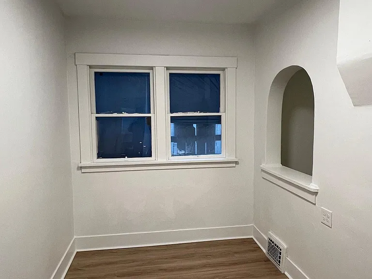 Cozy dining area with updated flooring and charming architectural details.