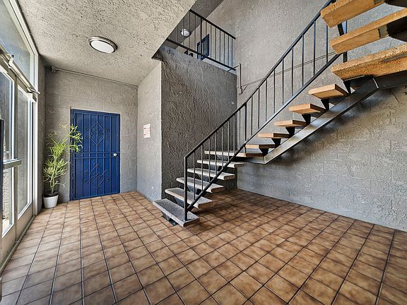 Clean interior corridor with convenient stair access to upper-level units.