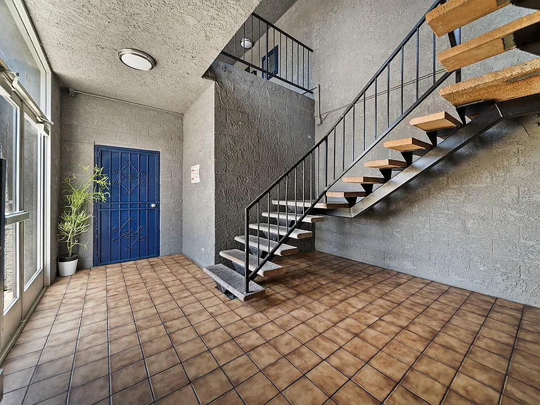 Clean interior corridor with convenient stair access to upper-level units.