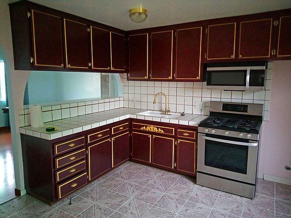 Unit B: Beautifly custom-painted cabinets. Stainless Steel LG range and matching microwave/range hood.