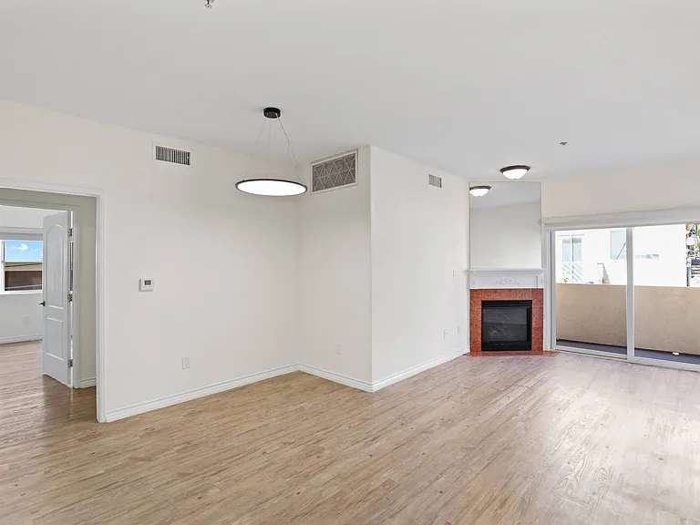 Open-Concept Dining and Living Room with Electric Fireplace and Private Balcony